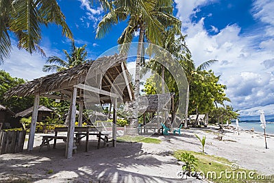 Modest huts with nipa roofs for rent to families looking to picnic by the beach. At Dumaluan Beach in Panglao Island, Bohol, Stock Photo