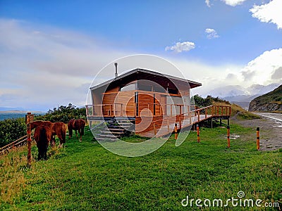 Modular wooden house in a natural environment and extreme landscape of Tierra del Fuego. Panoramic view of rural setting with Stock Photo