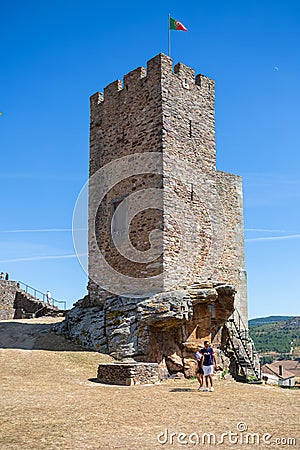 View at the exterior facade tower at Mogadouro Castle, tourist couple exploring the iconic monument building, portuguese patrimony Editorial Stock Photo