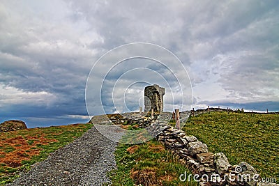 Moher Tower - Stone fence along road leading to Moher Tower Stock Photo