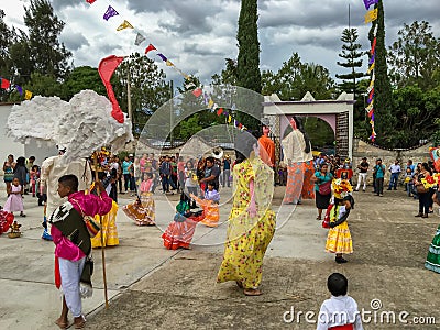 Mojigangas and children dancing at Calenda San Pedro in Oaxaca. Editorial Stock Photo