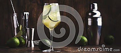 Mojito cocktail with lime and mint in wine glass on wooden background. Panoramic banner with copy space Stock Photo