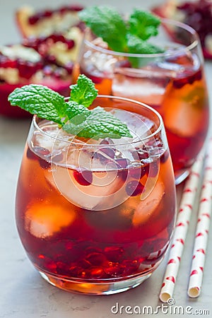 Mojito cocktail with pomegranate, mint, lemon juice and ice, vertical Stock Photo