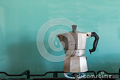 Moka coffe on gas flame. Italian typical coffee tool. Espresso coffe with light blue background and copy space Stock Photo