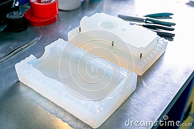 Mold for the manufacture of plastic parts. Manufacturing of plastic products. Medium business concept. Hands close-up Stock Photo