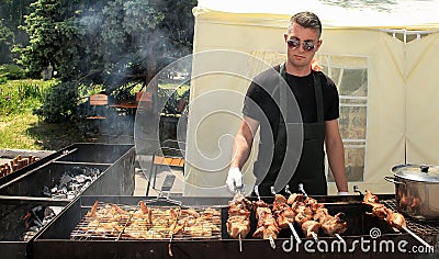 Moldova, Chisinau - 23.05.2015. BBQ fest. Young man fry a shish Editorial Stock Photo