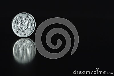 Moldova coin five bani 2008 on the edge on black background with reflection Stock Photo
