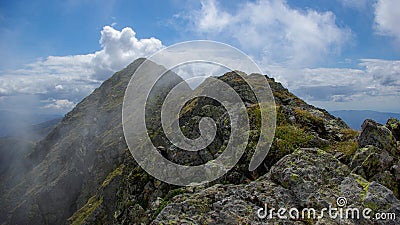 Moldoveanu Peak, Carpathian mountains, Fagaras, Romania. Mountain ridge in clouds. Stock Photo