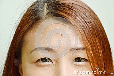 Mole in middle of Asian woman forehead shows physiognomy Stock Photo