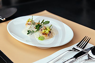 Molecular Creative Fine Dining: Hokkaido Scallop with green apple, hazelnut and shellfish veloute. Served in white plate. Stock Photo