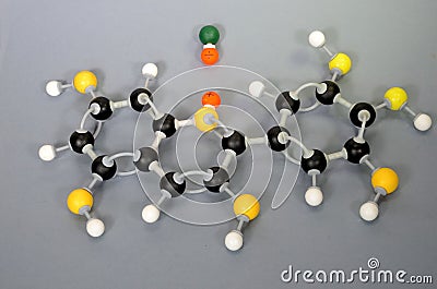 Molecule model of Paraffin. White is Hydrogen, black is Carbon, yellow is Oxygen and green is Chlorine. The orange spheres Stock Photo