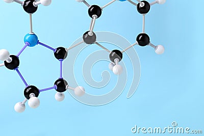 Molecule of nicotine on light blue background, closeup and space for text. Chemical model Stock Photo