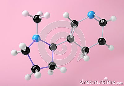 Molecule of nicotine on pink background. Chemical model Stock Photo