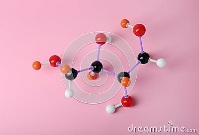 Molecule of sugar on pink background, top view. Chemical model Stock Photo