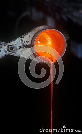 Molten gold in a crucible. Stock Photo