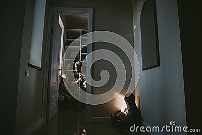 Mom abuses and punish her daughter and a little boy sitting in a corner. Stock Photo