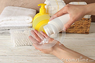 Mom applying talc powder from plastic tube Baby hygiene Stock Photo