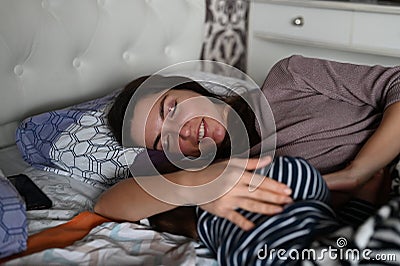 Mom and baby sleep happily. Mom smiles at her baby when sleeping. Calm dream of mother and baby Stock Photo