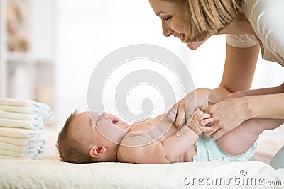 Mother changing a diaper on newborn baby Stock Photo