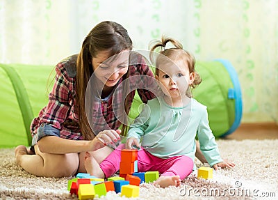 Mom and child daughter play block toys home Stock Photo