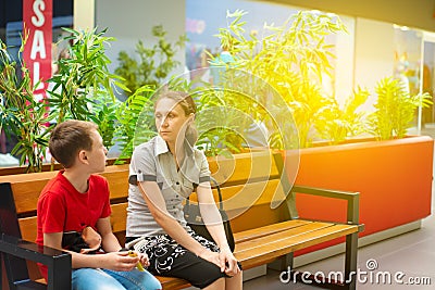 Mom with children on the bench in the mall. Photo with tinting Stock Photo