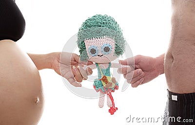 Mom and dad prepare girl doll for a new life Stock Photo