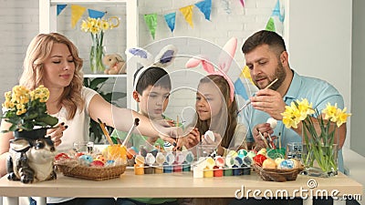 Portrait of a Happy Family with Two Children Drawing Easter Egg