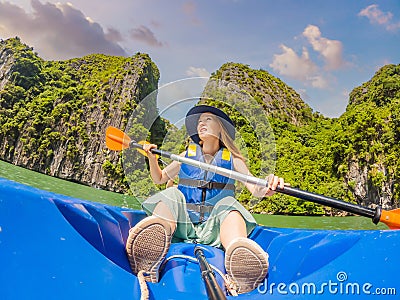 Mom, dad and son travelers rowing on a kayak in Halong Bay. Vietnam. Travel to Asia, happiness emotion, summer holiday Stock Photo