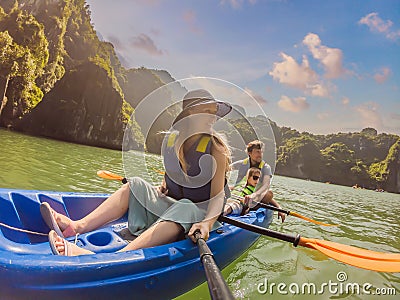 Mom, dad and son travelers rowing on a kayak in Halong Bay. Vietnam. Travel to Asia, happiness emotion, summer holiday Stock Photo