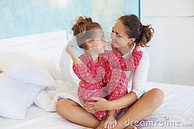 Mom with daughter in the bed Stock Photo