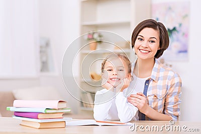 Mom and daughter are both smiling brightly Stock Photo