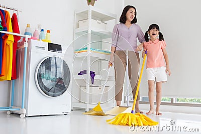 Mom and daughter cleaning house doing chore work at home Stock Photo