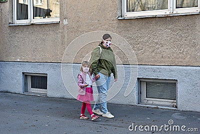 Mom and daughter with facemasks against coronavirus. Stock Photo