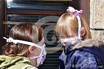 Mom and daughter with facemasks against coronavirus. Stock Photo