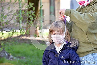 Mom and daughter with facemasks against coronavirus. Stock Photo