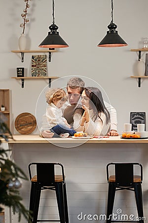 Mom and daughter in the kitchen celebrate Christmas. Care and love, warmth. Vertical frame Stock Photo