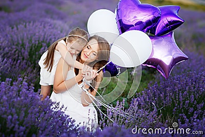 Mom and Daughter in the lavender field. Family love concept. Stock Photo