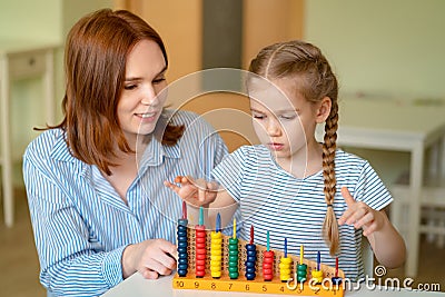 Mom with daughter learning to add and subtract Stock Photo