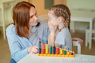 Mom with a daughter learning to add and subtract Stock Photo