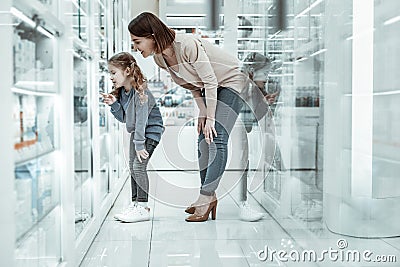 A cute little daughter showing the vitamins to her smiling mom. Stock Photo