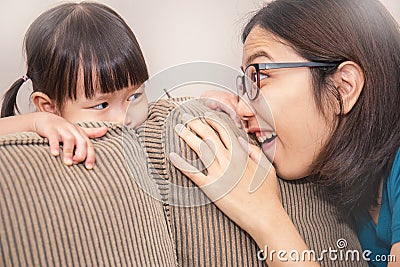 Mom and daughter play hide and seek Stock Photo