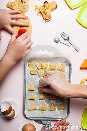 Mom and daughter are playing bakery. Prepare homemade cookies with dough berries Stock Photo