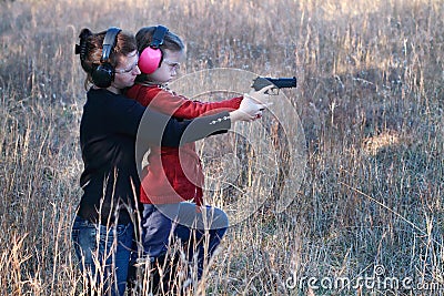 Mom and Daughter Practicing Shooting Stock Photo