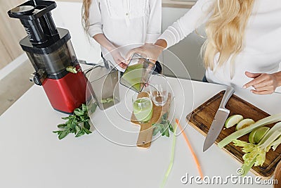 Mom daughter preparation detox cocktail celery apple kitchen healthy lifestyle Stock Photo