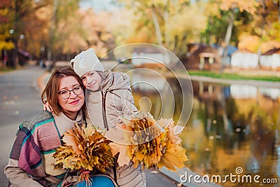 Mom and daughter and walk in the autumn Park near the lake Stock Photo