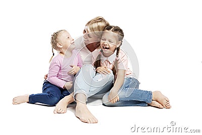 Mom and daughters are sitting and laughing. Love and tenderness. Isolated over white background Stock Photo