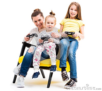 Mom and daughters playing console Stock Photo