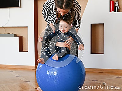 Mom is doing exercises for the baby. Baby and mom develop body motility Stock Photo