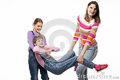 Mom with the eldest daughter rock the youngest daughter in her arms Stock Photo