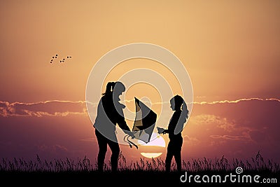 Mom and girl with kite at sunset Stock Photo